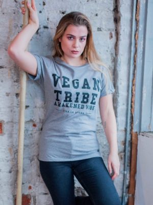 A female model wearing Unisex grey marl tshirt. designed by eco-ethical brand Viva La Vegan with the words Vegan Tribe across the front