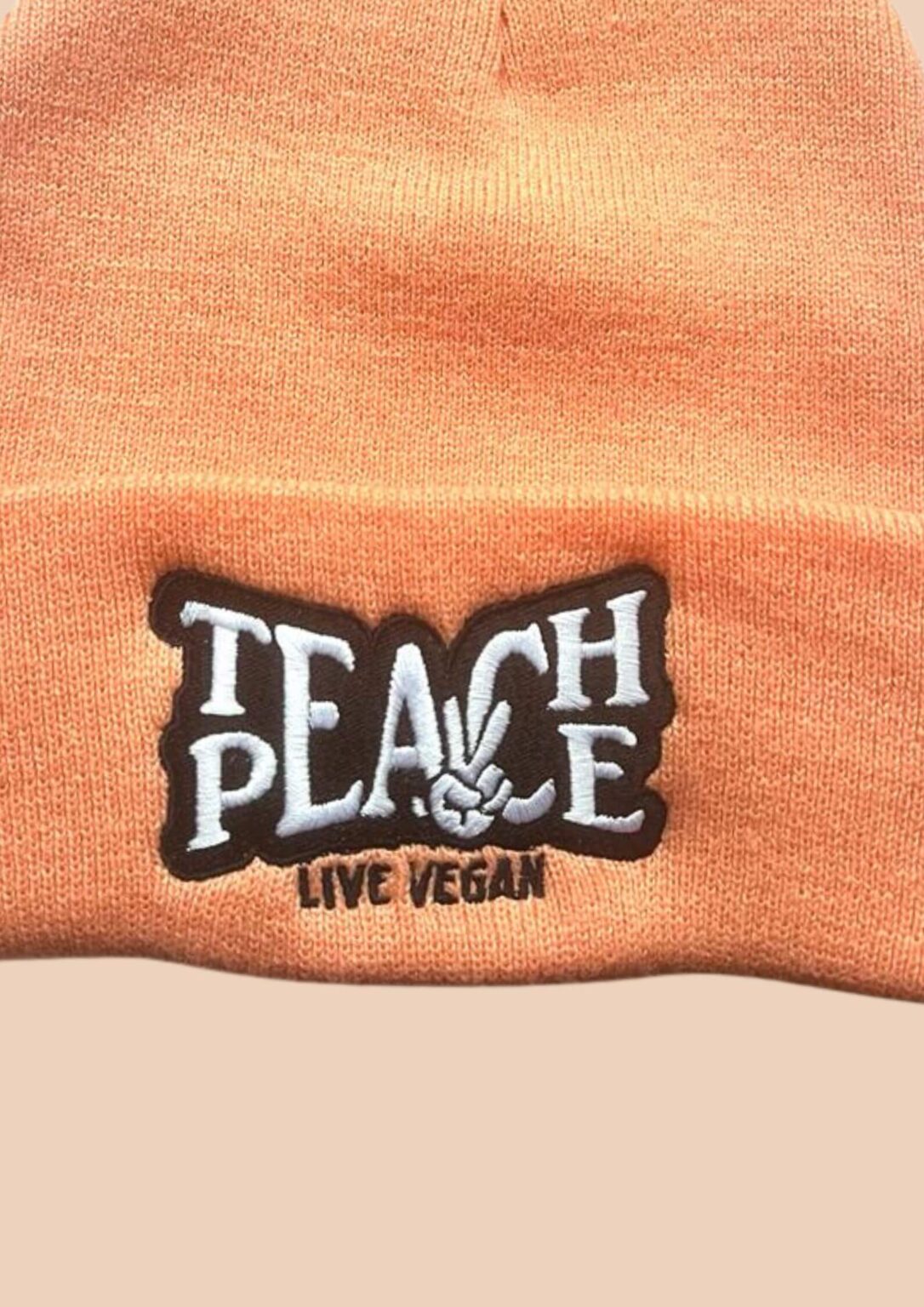 teach-peace-blush-beanie-close