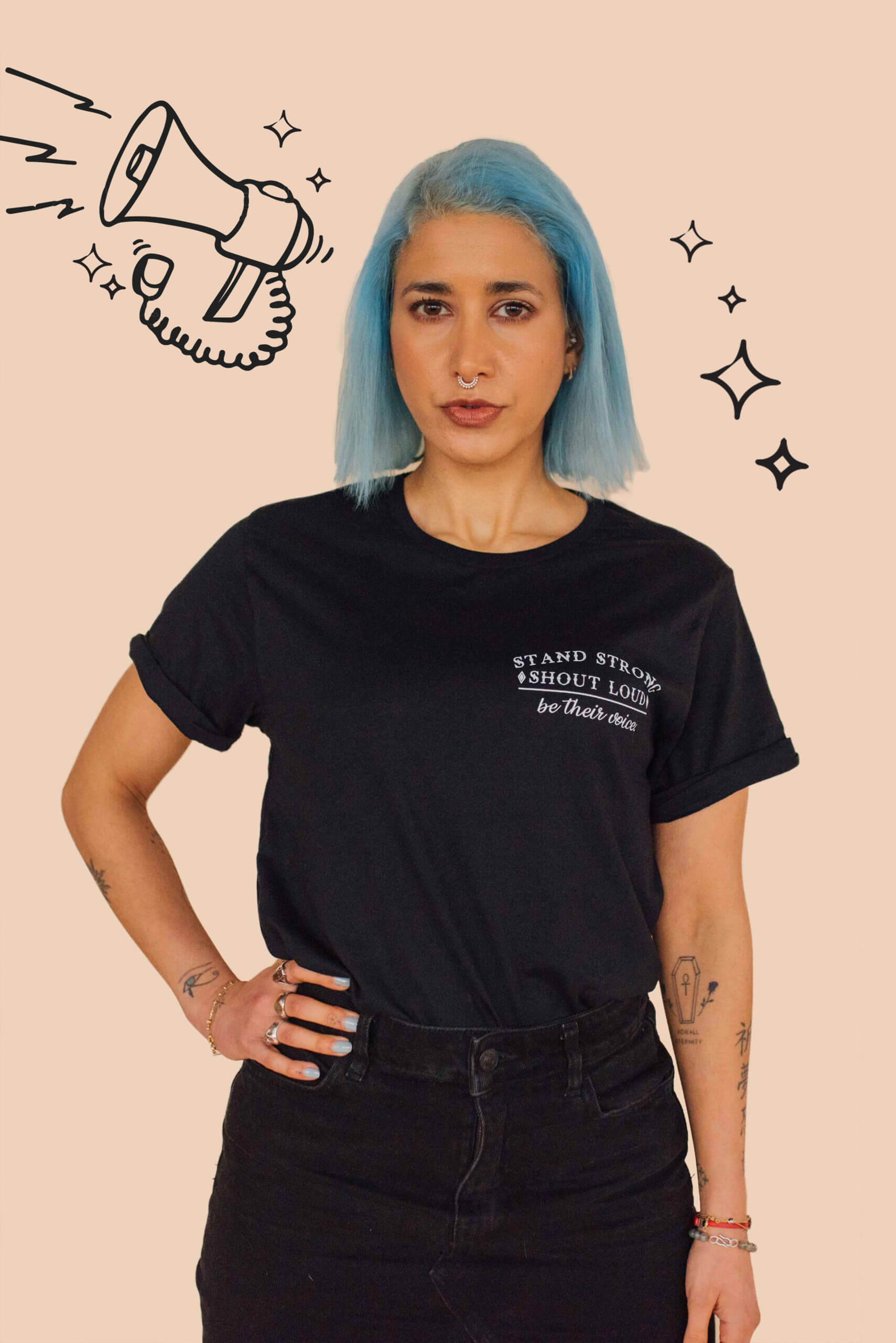 A blue haird model standing against a wall wearing Eco-ethical brand Viva La Vegan's black "Silence is not a option" t-shirt.