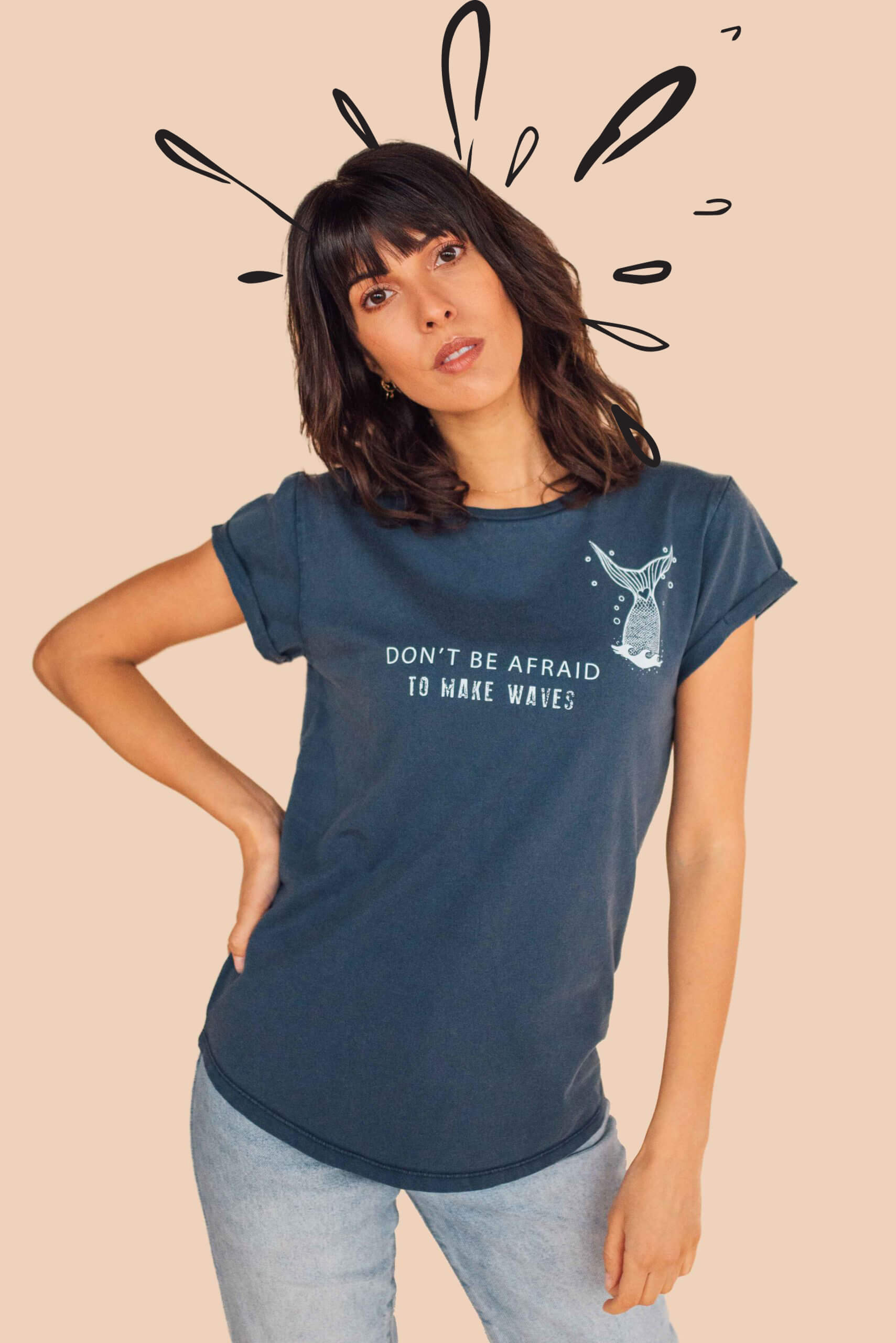 Model wearing the eco-ethical brand Viva La Vegan's "Mermaid revolution t shirt" showing a decorative denim blue tshirt with illustration and the words "Don't be afriad to make waves"